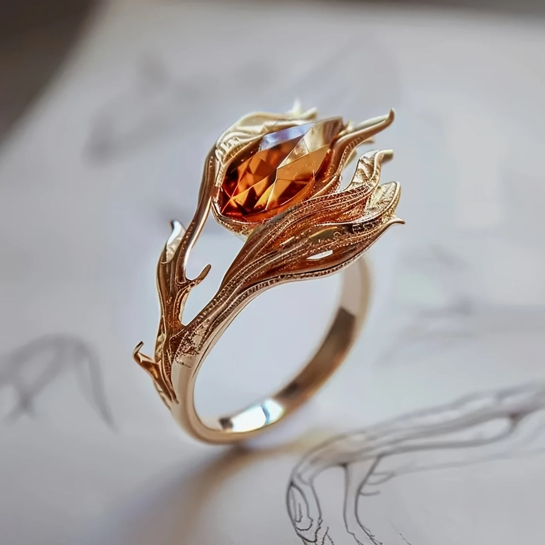 Ring i guld med orange krystal